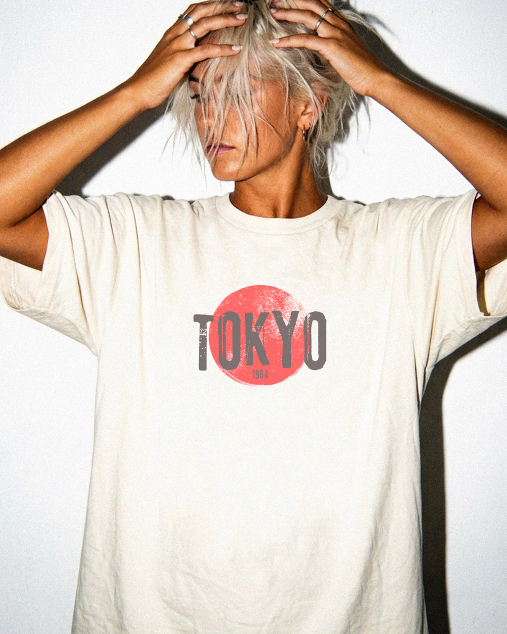 Woman wearing Edit Inc. Tokyo 1964 graphic tee in Ivory.